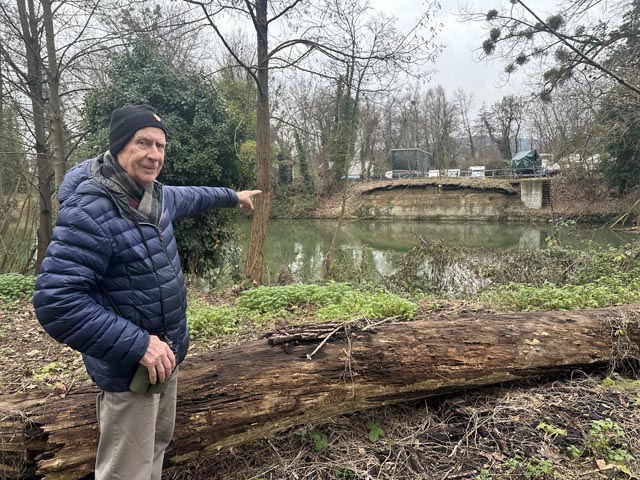 Urs Wullschleger zeigt auf die Eisvogelwand an der gegenüberliegenden Uferseite der Ergolz, in welche die bunten Vögel Bruthöhlen bauen. Foto: Sonja Fasler
